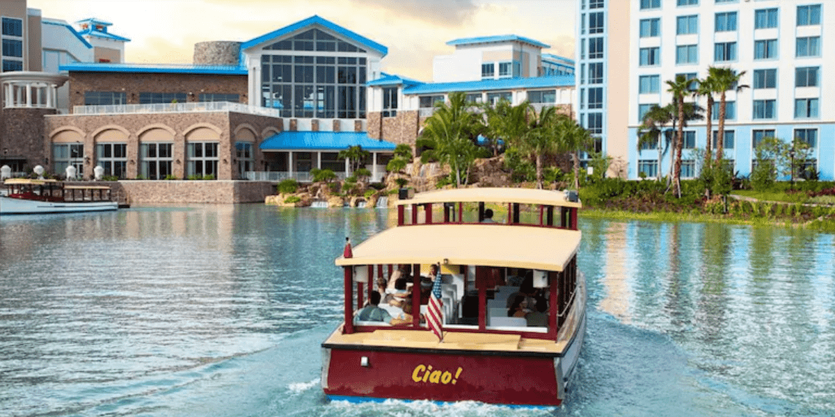 a red boat sails through the water at Sapphire Falls hotel.