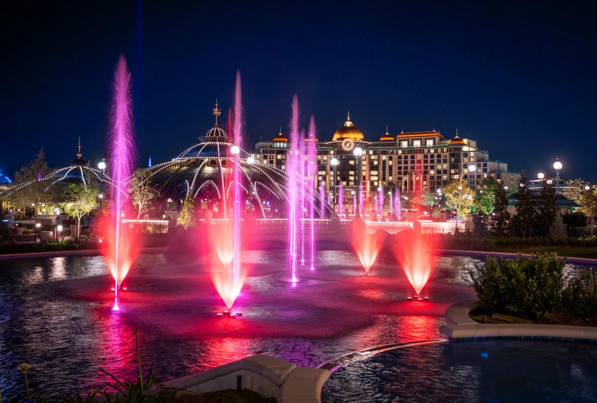 Universal Celestial Goodnight Testing Points to Epic Universe Fireworks Show 3 Celestial Park fountain jets glowing at night with Universal Helios Grand Hotel in the background