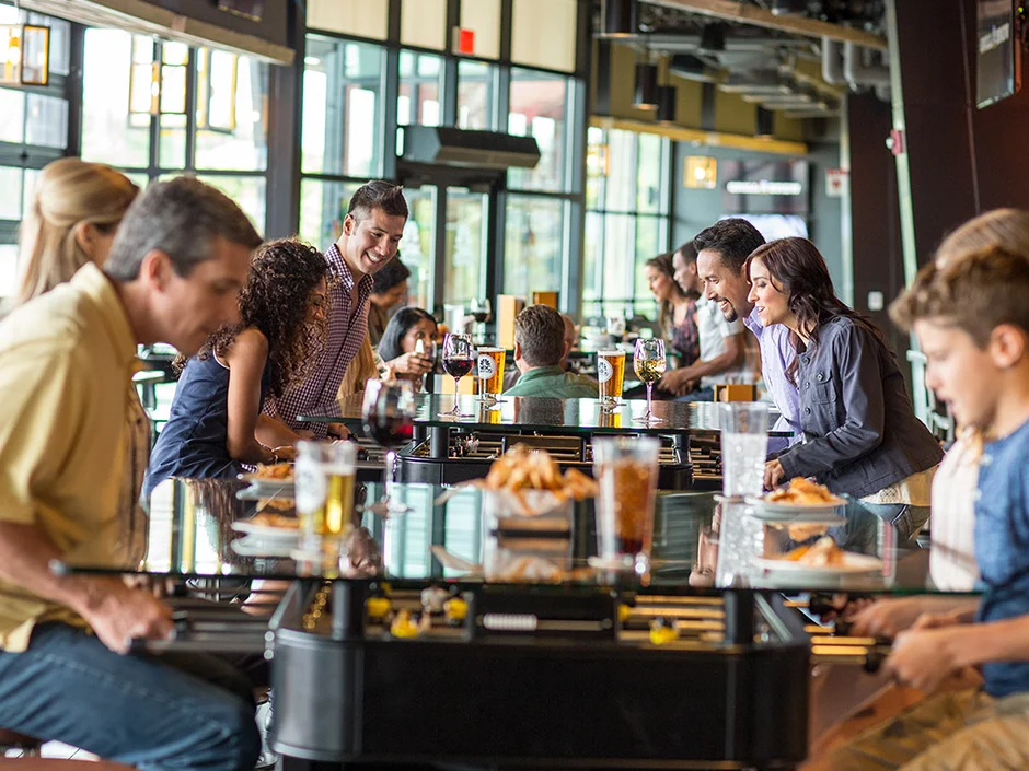 Universal Orlando Fall 2026 Guide: Events, Weather & Tips 14 Guests dining together at NBC Sports Grill and Brew