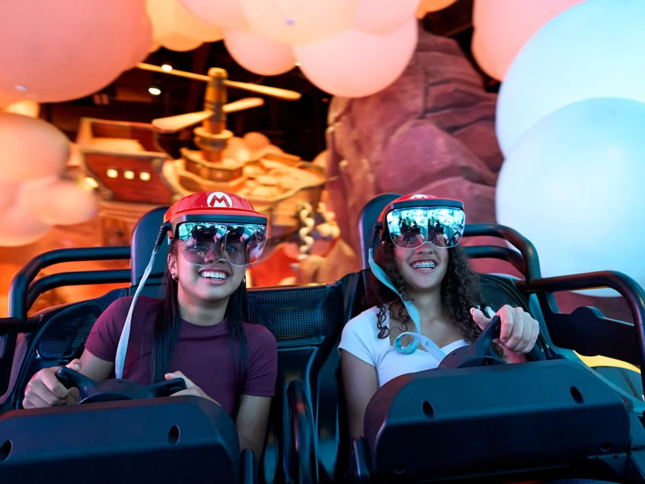 Mario Kart: Bowser's Challenge at Epic Universe: How the Race Really Works 3 Guests steering Mario Kart: Bowser’s Challenge at Universal Epic Universe