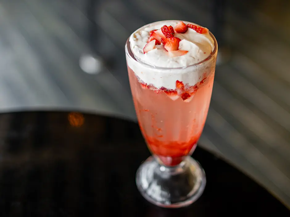 CityWalk Adds a Mac and Cheeseburger for Football Season 3 Pink strawberry soda topped with white foam and strawberry pieces