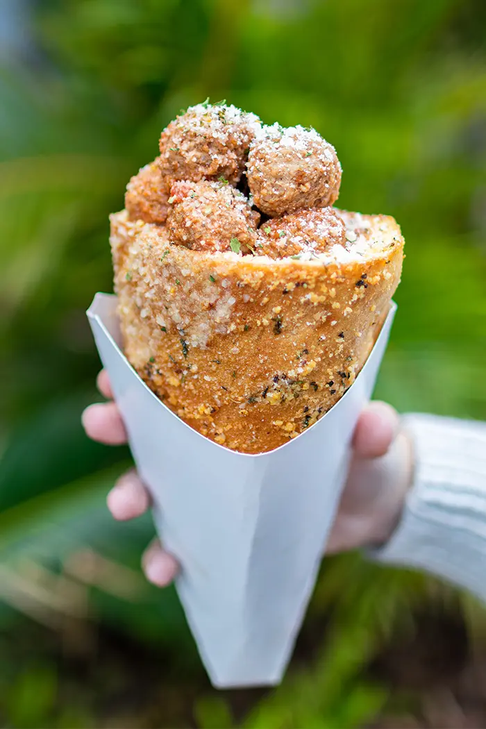 Universal Orlando's Bread Cone Craze Now Spans Two Parks 3 Hand holding a Meatball Marinara Bread Cone in Jurassic Park