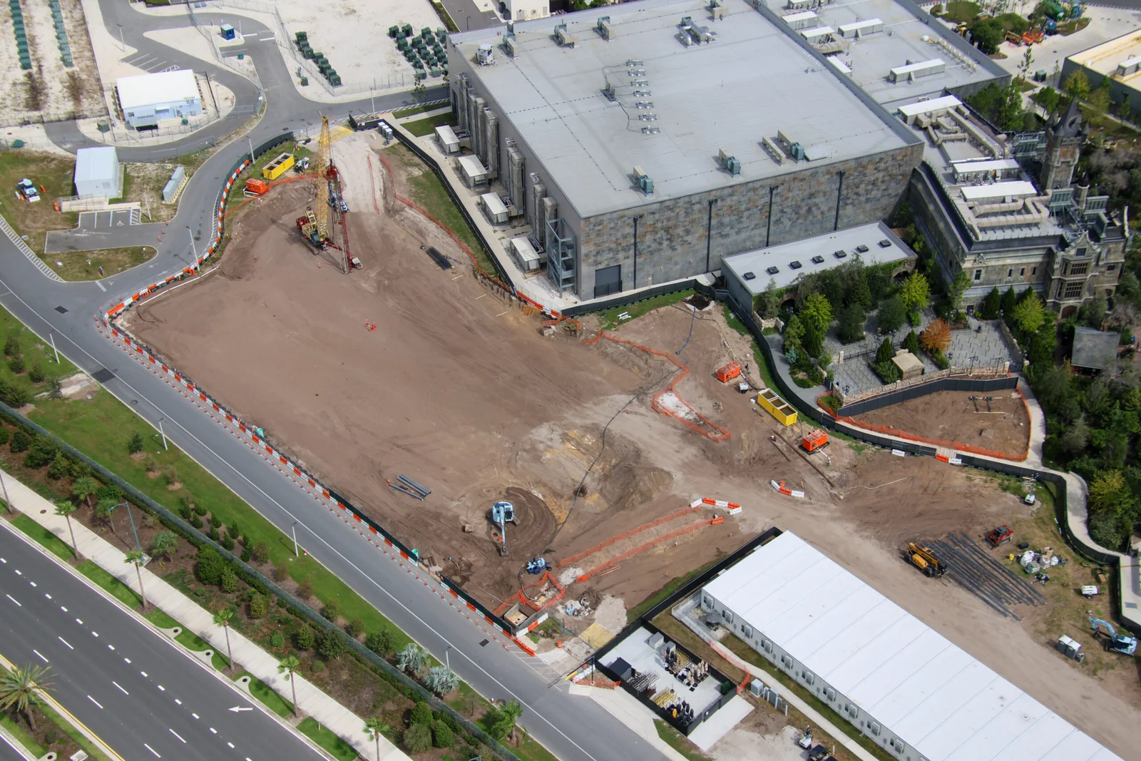 Foundation Work Advances Behind Dark Universe at Epic Universe 3 Reverse aerial view of the graded construction site behind Monsters Unchained