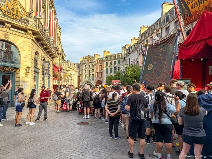 Epic Universe Crowds Ease, but Two Rides Still Need a Plan 6 Guests queue outside the Metro-Floo entrance in wizarding Paris