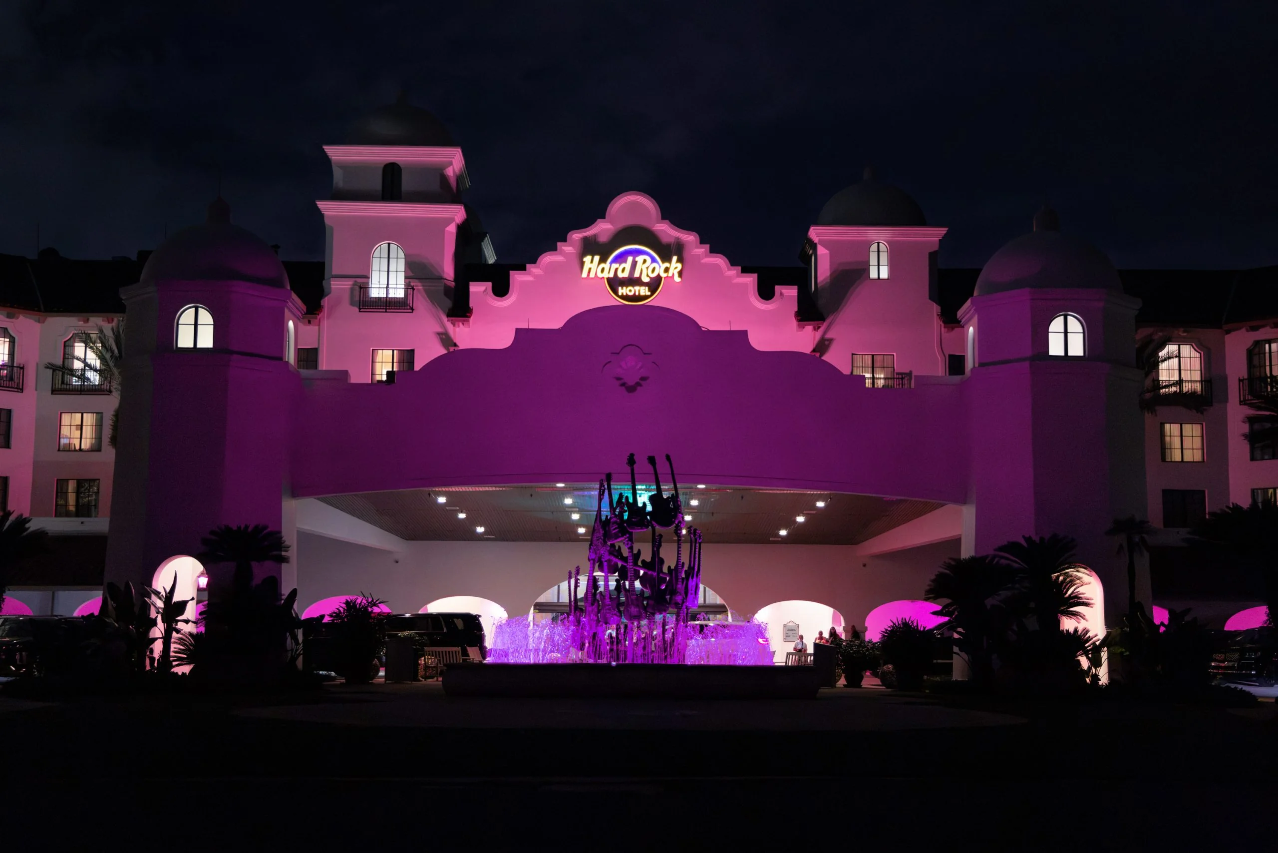 Hard Rock Hotel Goes Pink With October Brunch and Drink Donations 2 Hard Rock Hotel entrance and guitar fountain illuminated in pink at night