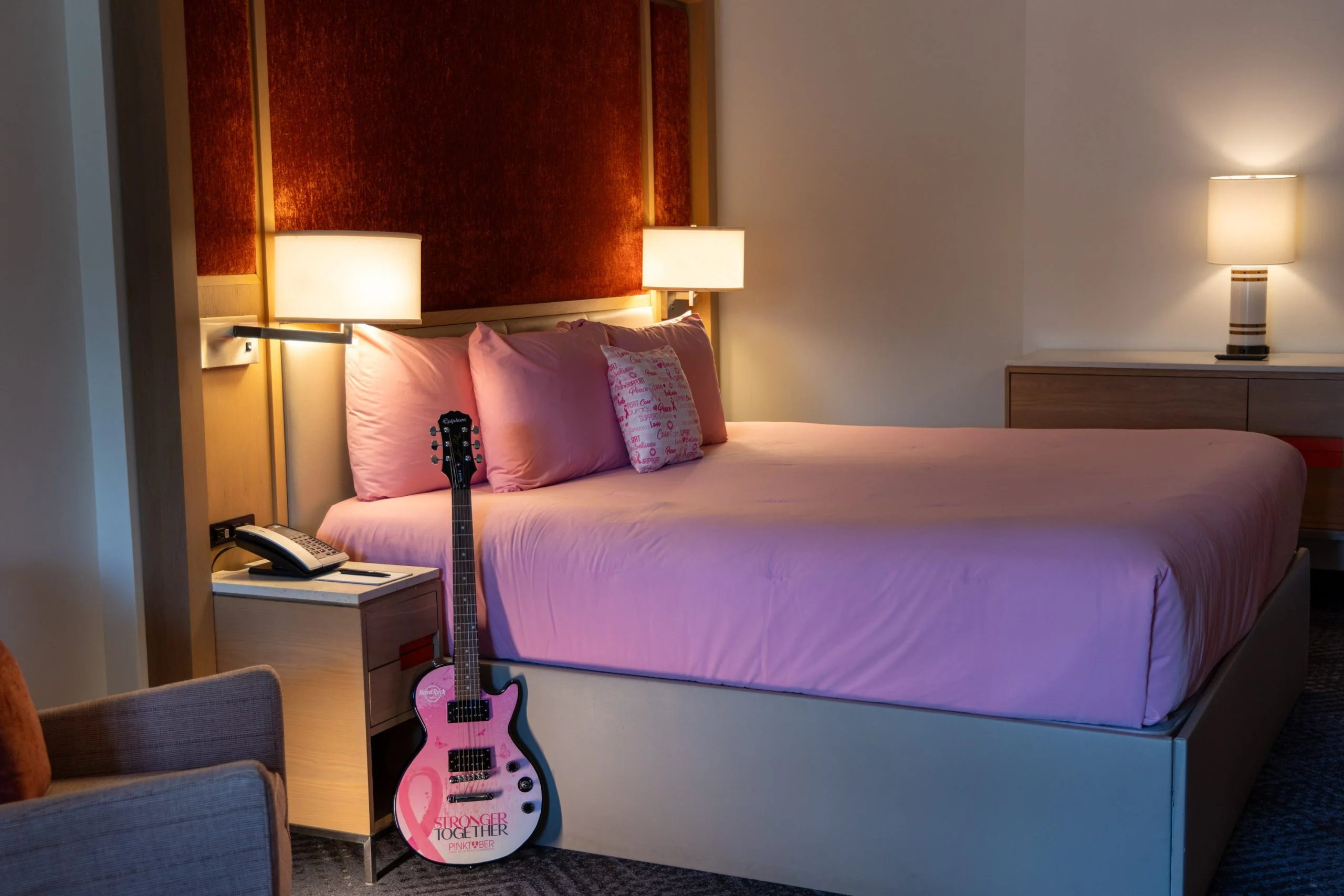 Hard Rock Hotel Goes Pink With October Brunch and Drink Donations 1 Hard Rock Hotel guest room with pink bedding and a Pinktober guitar beside the bed