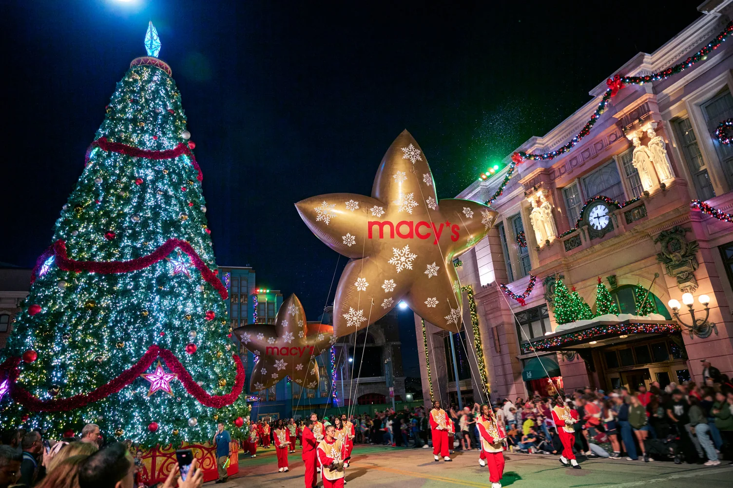 Earl the Squirrel Balloon Will Join Universal Orlando Holiday Parade 2 Universal's holiday parade passing a Christmas tree at Universal Studios Florida