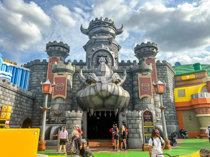 Epic Universe Crowds Ease, but Two Rides Still Need a Plan 3 Bowser's Castle entrance with a stone Bowser face above the doorway