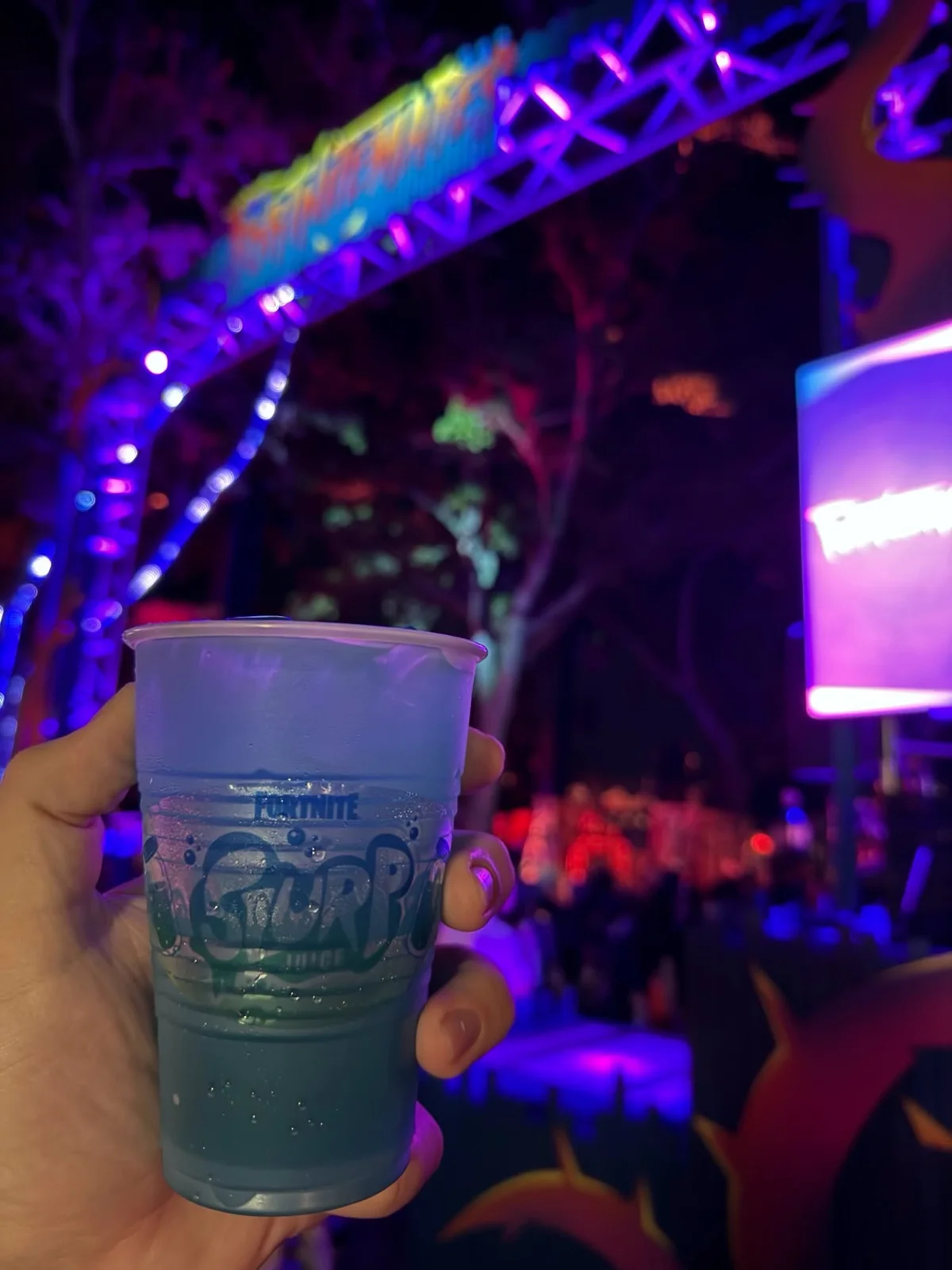 Fortnite's Slurp Juice Is Reported at HHN Orlando for $10 2 Hand holding a blue Slurp Juice drink in a Fortnite-branded cup