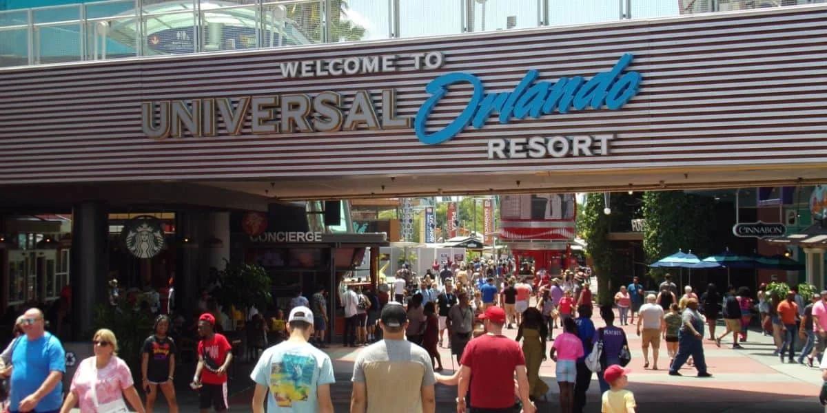 Wicked Comes to CityWalk for One Day: Meet Glinda and Elphaba October 24 2 Guests walking beneath the Universal Orlando Resort arch at CityWalk