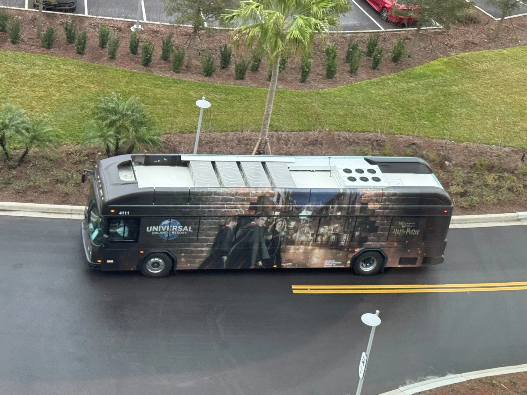 Epic Universe Uses Floating Solar Panels to Charge Electric Buses 1 Universal Orlando bus with a Harry Potter-themed wrap traveling along a road